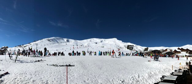 People on snow covered mountain against sky