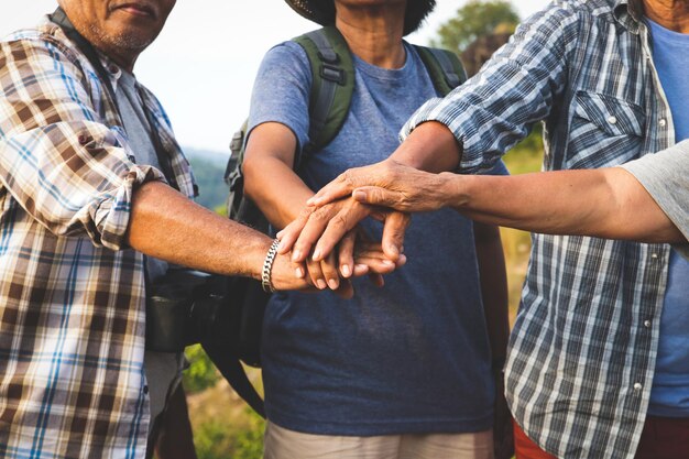 Photo people stacking hands while standing on land