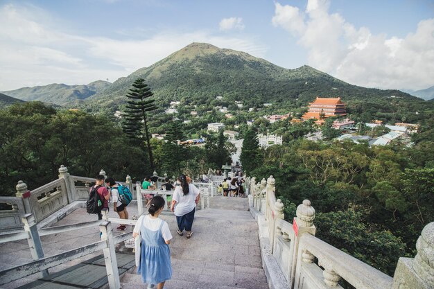 People on staircase against mountain range