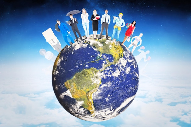 Photo people standing on earth against white clouds under blue sky