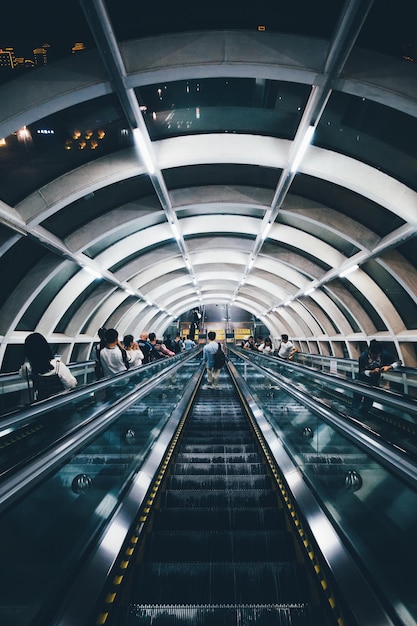 people standing on escalator