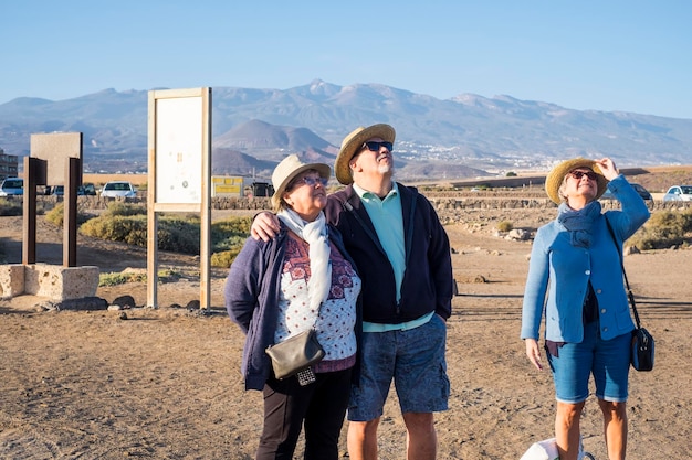 People standing on mountain against sky