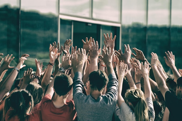 Photo people standing with arms raised