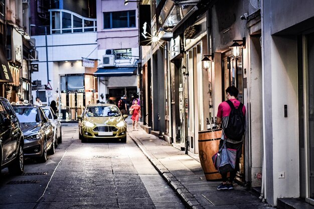 People on street amidst buildings in city