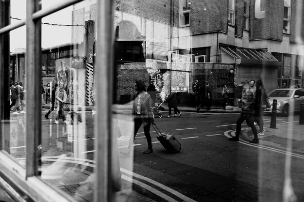 Photo people on street reflecting on glass window