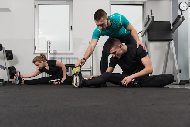 People stretching during fitness class in fitness center