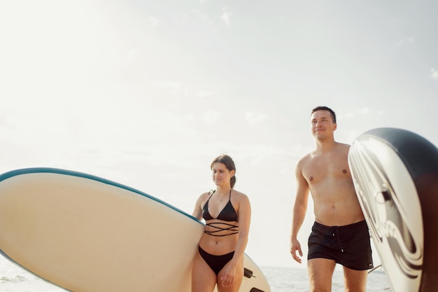 People surf an active lifestyle go for a ride on the sup board Summer lake friends go on vacation