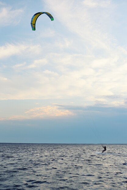 People swim in the sea on a kiteboard