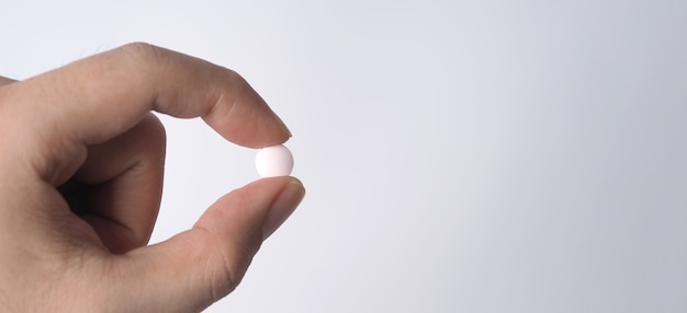 People taking or holding a white medicine pill in hand which help and protect from pandemic virus and relief them from unhealthy and sickness.