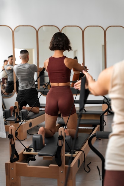 People taking  pilates reformer class