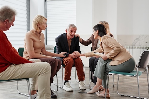 People talking to depressed man