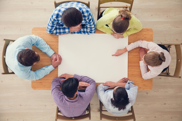 People team pointing to white paper