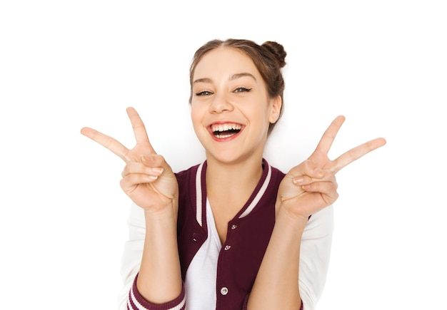 people and teens concept - happy smiling pretty teenage girl showing peace sign