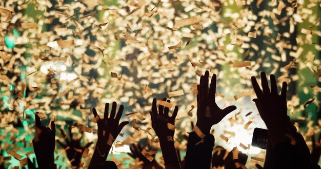 Photo people throwing confetti in mid-air during celebration