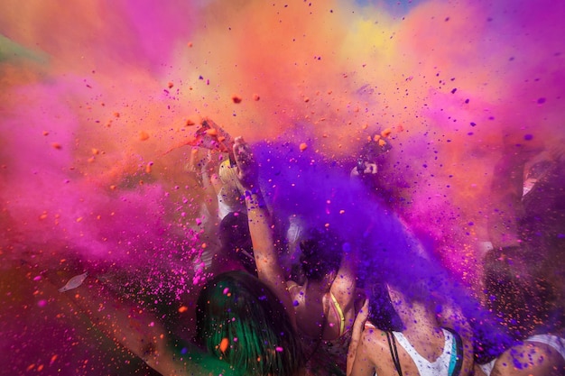 people throwing powder paint during holi celebration
