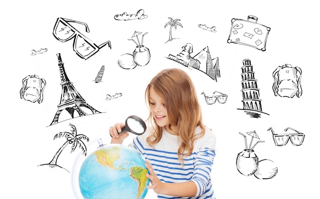 people, tourism, vacation and summer holidays concept - little student girl looking at globe with magnifier over touristic doodles