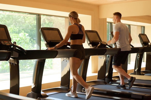 People training on treadmill in gym