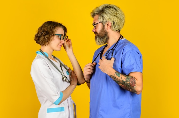 People in uniforms yellow background Medical staff trust our professionals healthcare business teamwork and people concept doctor and nurse Successful team of medical doctors Be Safe