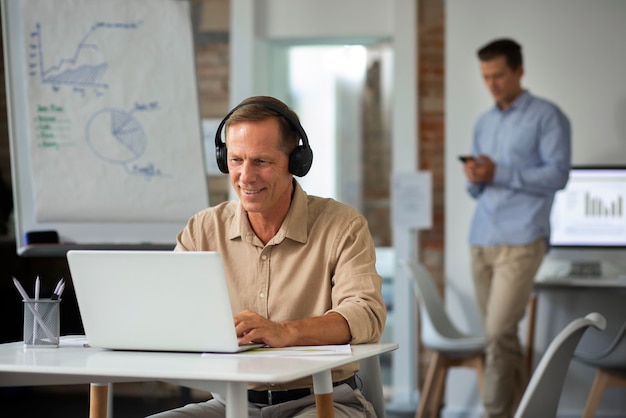 Photo people using digital device while in a meeting