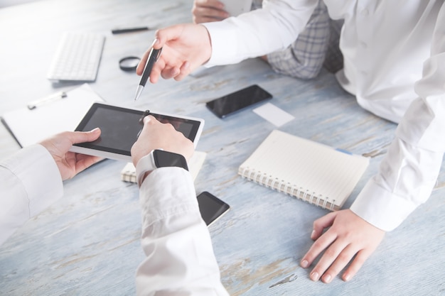 People using digital tablet in office.