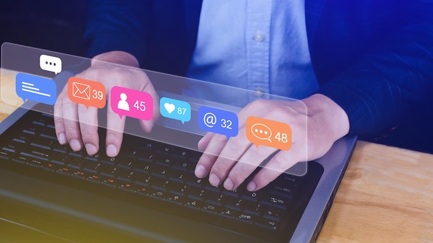 Photo people using touching social media and digital online marketing concepts on laptop with icons such as notifications messages comments on the screen