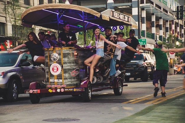 People on Vehicle and People Running Photo