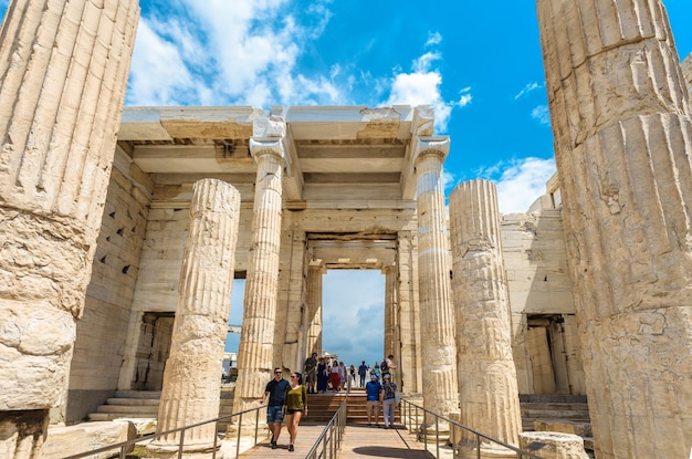 People visit Ancient Greek Propylaea on famous Acropolis of Athens Greece