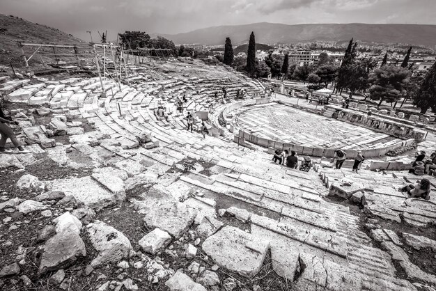 People visit Theatre of Dionysus at foot of Acropolis Athens Greece Europe