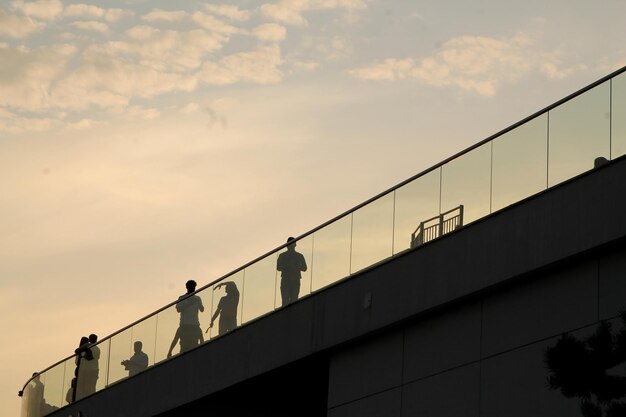 People walk on the bridge on a summer evening