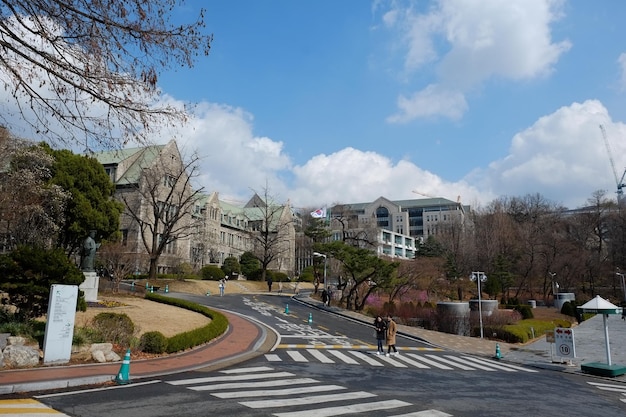 People walk at Ewha Womans University on MARCH 232019 in SeoulKoreaEwha Womans University is currently the world39s largest female educational institute