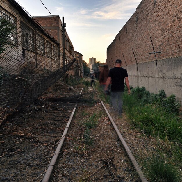 Photo people walking by abandoned railroad track