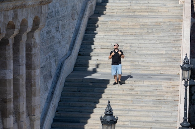 People walking by stone stairs with backpack