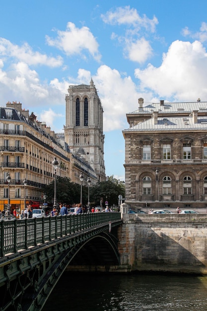 People walking and crossing a bridge in Paris city center