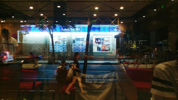 Photo people walking in illuminated city at night