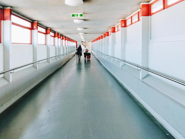 People walking in illuminated corridor