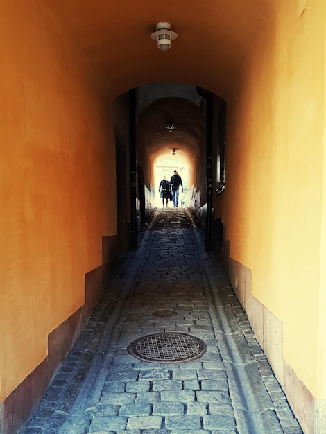 People walking in illuminated corridor