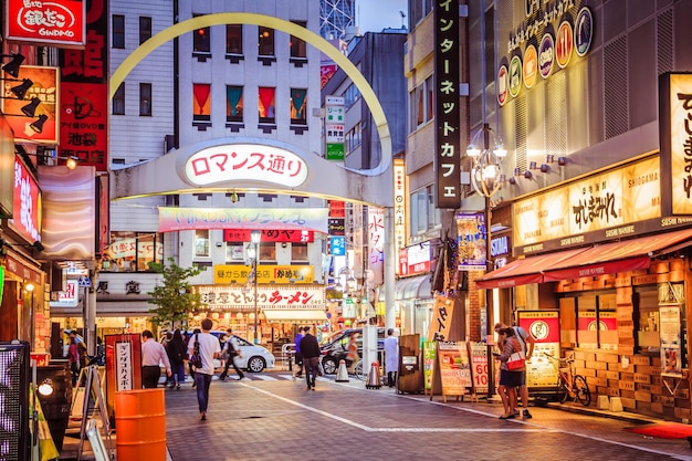 写真 照らされた街を歩く人々