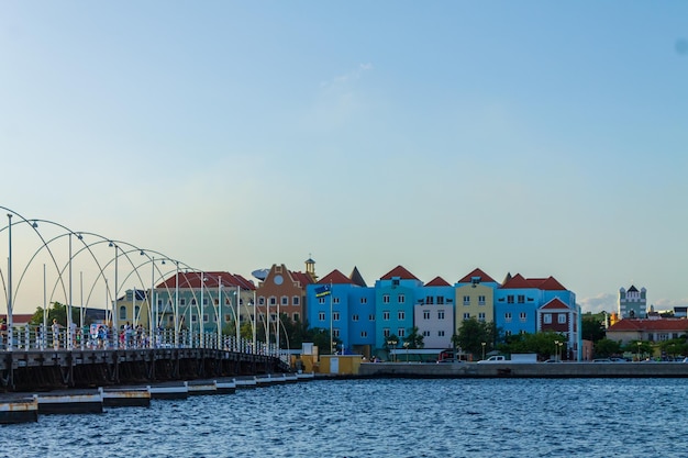 People walking on the Queen Emma floating bridge in Willemstad Curacao