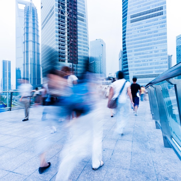 People walking on street amidst buildings in city