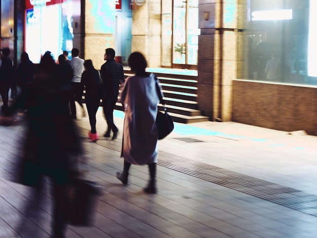 People walking on street at night