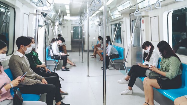 People wearing face masks on a crowded public subway train