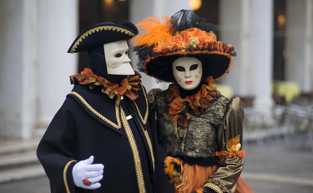 People wearing masks and costumes on street during carnival