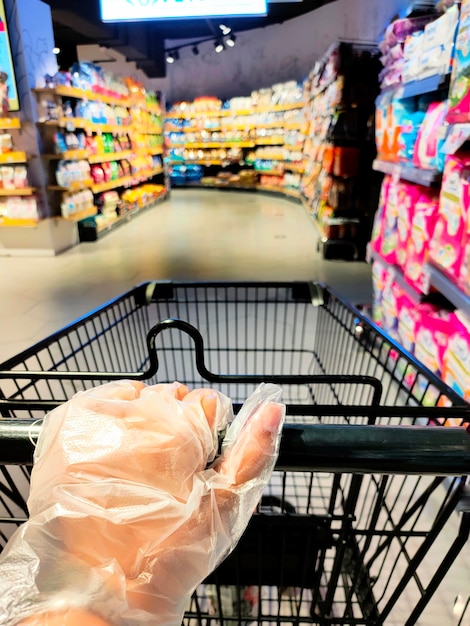 People wearing plastic gloves shopping in supermarket new normal because of CoronaVirus Covid19