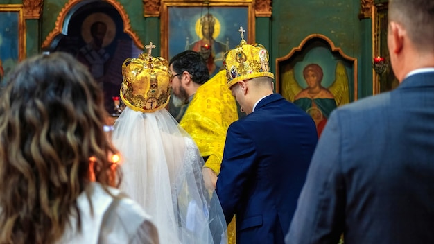 People at wedding ceremony, orthodox priest serving in a church