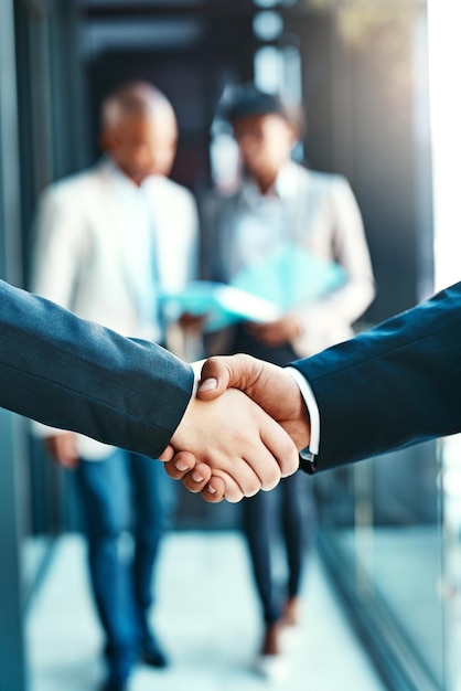 Photo people will fear this partnership cropped shot of two businesspeople shaking hands