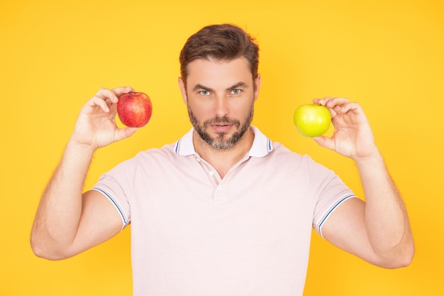 People with apple portrait of man eating apple isolated over studio background healthy apple fruit f