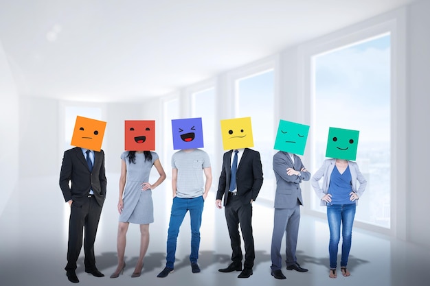 People with boxes on their heads against bright white corridor with windows