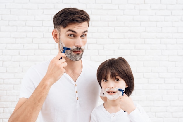 People with dark-haired learns to shave.