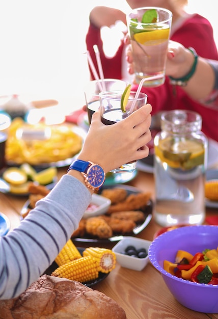 People with drinks while sitting at the dining table