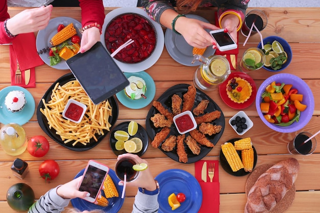 People with drinks while sitting at the dining table